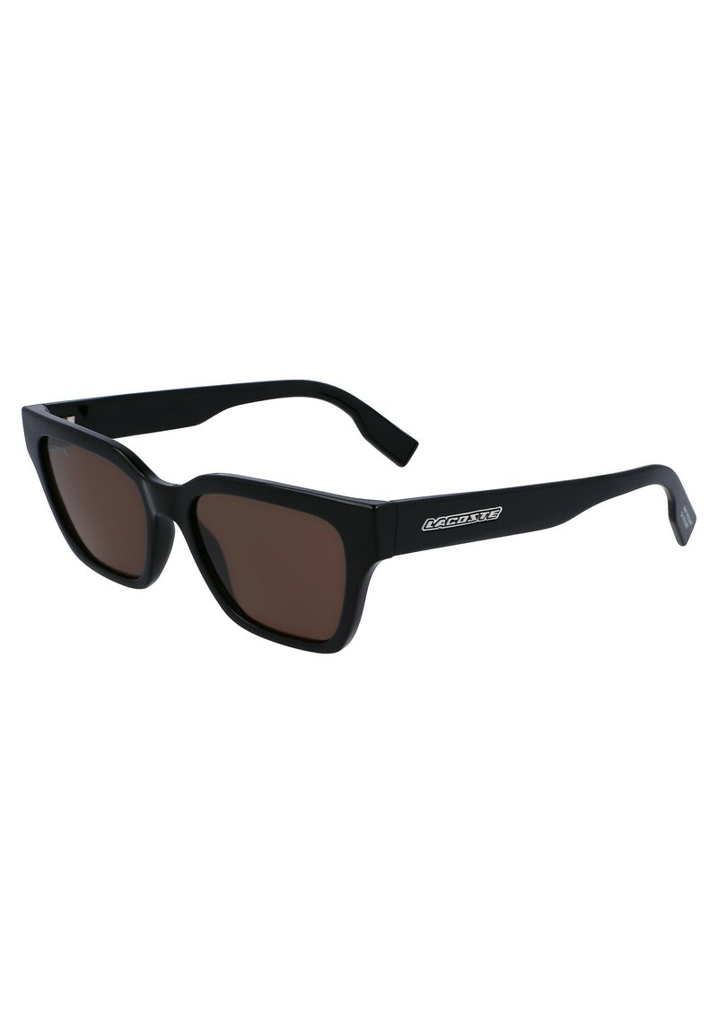 Black plastic sunglasses with brown lenses, featuring a geometric design, wide frame, and a logo on the arm. Textured temple tips for grip.