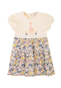 Abito crema a maniche corte con ricamo di giraffa e gonna a fantasia floreale nei toni del rosa, blu e giallo. Presenta un'apertura sul retro.