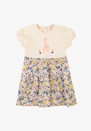Abito crema a maniche corte con ricamo di giraffa e gonna a fantasia floreale nei toni del rosa, blu e giallo. Presenta un'apertura sul retro.