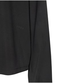 Čierna košeľa s dlhým rukávom a hladkou textúrou, s jemným logom "CPNHGN" potlačeným na boku a zaobleným lemom.