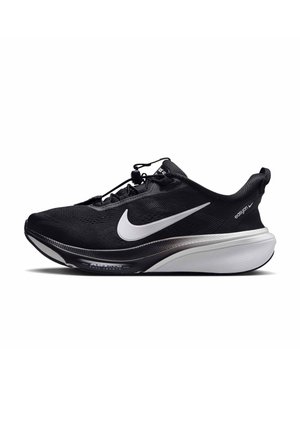 Scarpa da corsa Nike nera con logo swoosh bianco, suola spessa bianca e nera, linguetta di estrazione e sistema di allacciatura rapida su sfondo bianco.