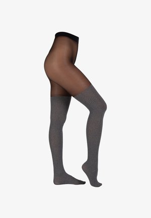 Collant neri opachi fino alla coscia con una fascia superiore grigia a coste. Il materiale sembra liscio ed elastico, adattandosi alla forma della gamba.
