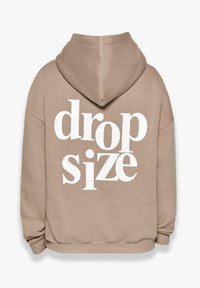 Beige Kapuzenpullover mit großem weißen Aufdruck "drop size" auf dem Rücken. Verfügt über eine geräumige Kapuze und eine lockere Passform. Weiches, strukturiertes Material.