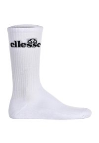 Chaussette en coton blanche avec texture côtelée, comportant un logo "ellesse" noir près du haut. Longueur standard de type crew, avec renfort au talon et aux orteils.