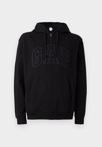 Black zip-up hoodie with front pockets, drawstring hood, and subtle embossed GAP logo across the chest.