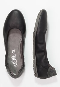 Black leather ballet flats with textured accents, a cushioned insole, and a gray rubber sole featuring a tread pattern for traction.