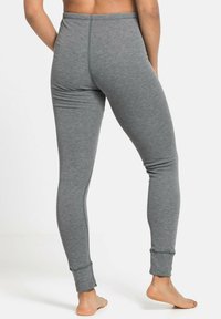 Gray leggings made of soft cotton material, featuring a snug fit, tapered legs, and a cuffed hem at the ankle. Minimal seam detailing.