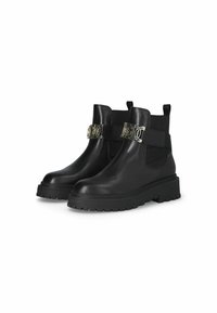 Black leather ankle boots with textured elastic panels, thick rubber soles, and metallic strap detailing. Double pull tabs for easy wear.