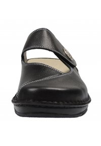 Black leather shoe with a rounded toe, adjustable strap, and decorative button detail. Features contrast stitching and a cushioned insole.