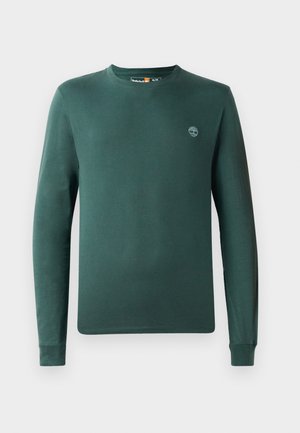 Langermet skjorte i mørkegrønn bomull, med rund hals og ribbestrikkede mansjetter, og en liten logo på venstre bryst.