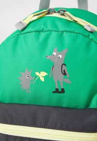 Green backpack with a textured finish, featuring a gray fox and a hedgehog graphic holding a leaf. Accented with yellow zippers and a dark base.
