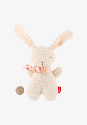 Peluche lapin beige doux avec de longues oreilles, une écharpe fleurie rose et une boîte à musique à tirette fixée sur le côté gauche.