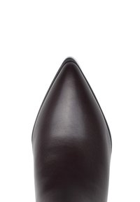 Brązowy skórzany but na wysokim obcasie z zaostrzonym noskiem. Gładka powierzchnia i minimalne przeszycia, z elegancką sylwetką.