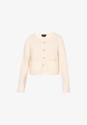 Cardigan scurt de culoare crem, cu un tricotaj texturat, având trei nasturi, două buzunare frontale și fundițe decorative deasupra nasturilor.