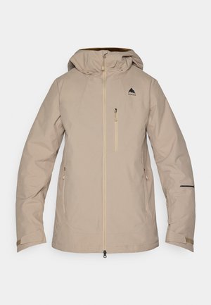 Beige nepromokavá bunda s kapucí, předním zipem, bočními kapsami a černým logem na levé hrudi. Hladká textura a štíhlý design.