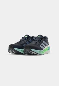 Men's running shoes in navy and mint green. Features include a textured mesh upper, three white stripes, and a cushioned sole for support.