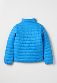 Modrá zateplená bunda s vysokým límcem, jejíž design zahrnuje vodorovné prošívané části a elastické manžety. Lehký materiál s hladkou texturou.