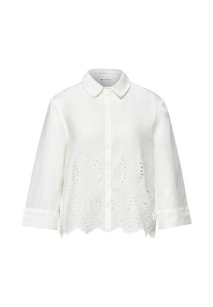 Weißes, langärmliges Hemd mit Knopfleiste, spitzem Kragen und floraler Lochstickerei entlang der unteren Vorderseite und mit wellenförmigem Saum.