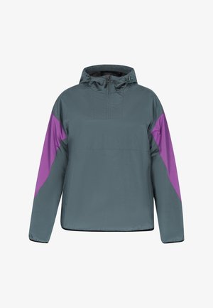Coupe-vent gris avec une demi-fermeture éclair, présentant des panneaux latéraux violets, une capuche et une coupe légèrement ample. Matériau texturé et léger.