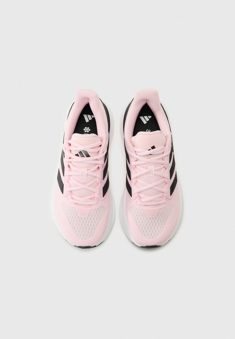 Scarpe sportive rosa con accenti neri, tomaia in mesh e suola bianca. Presentano lacci e logo sulla linguetta e sul lato.