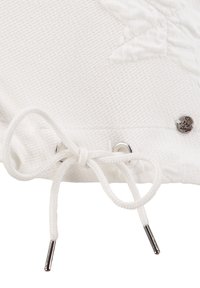 White textured fabric with a drawstring at the bottom, featuring silver grommets and a small metallic accent with "Key of Bingo" engraving.