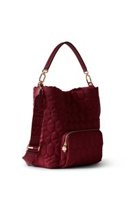 Burgundy quilted fabric handbag with a textured hexagonal pattern, gold hardware, a top handle, and a front zip pocket.
