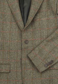 Groene tweed blazer met een bruin en rood geruit patroon, enkelvoudig met één knoop en vier knopen detail op de manchetten.