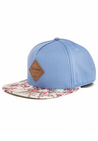 Blue snapback cap with a floral-patterned brim and a brown leather label on the front. Fabric is smooth with structured design.