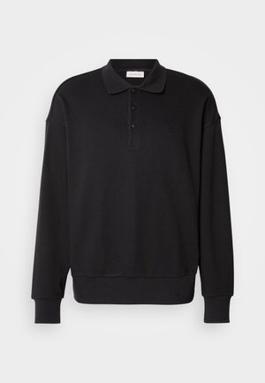 Black long-sleeve polo shirt, ribbed texture, three-button placket, embroidered logo on chest, fitted cuffs and hem. Soft cotton blend material.