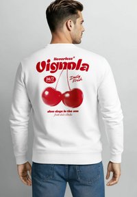 White sweatshirt featuring red graphic text and two cherries on the back. Text includes "Neverless," "24/7," and "Daily Fresh," with dotted accents.