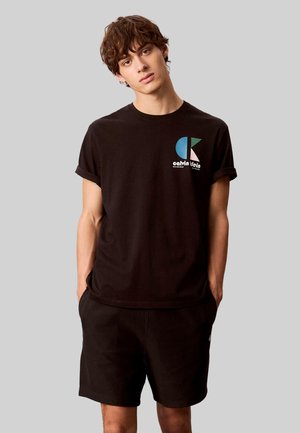 PREMIUM MONOGR - Shorts - black