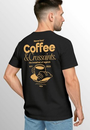 Black t-shirt featuring gold print on the back, displaying "Coffee & Croissants," cup, croissant graphic, and establishment year 2025.