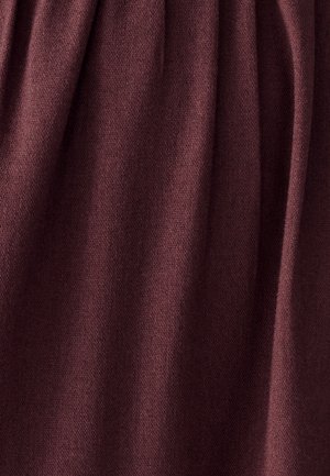 Burgundy fabric, soft texture, and slightly wrinkled surface with a uniform weave pattern, showcasing rich color depth and warmth.