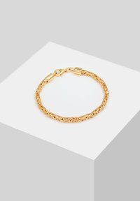 Bracelet chaîne en or avec maillons entrelacés, équipé d'une fermeture à fermoir. La surface brille d'une finition lisse et polie.