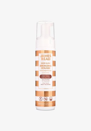 Bronzing mousse in a white and gold striped bottle. Features a pump top and labels in English and German. Contains aloe vera and green tea extract.