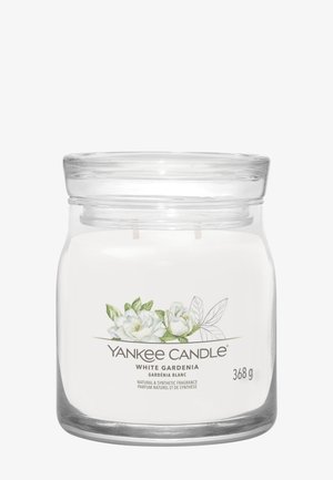 Glazen potkaars met label Yankee Candle White Gardenia, voorzien van een bloemrijke illustratie en een gewichtsaanduiding van 368g.