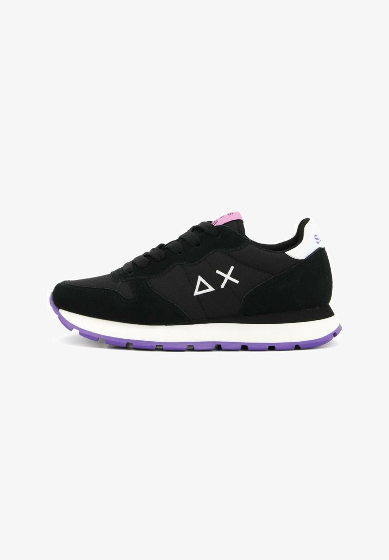 Black sneaker with suede and mesh materials, white accents, purple sole, and geometric patterns on the sides. Features round laces and padded collar.