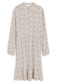 Robe crème à manches longues avec un motif de points noirs irréguliers, devant boutonné, col et ourlet froncé.