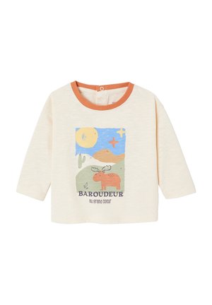 Cream long-sleeve baby shirt with orange collar and a colorful moose landscape design featuring sun, hills, and text "BAROUDEUR au grand coeur".