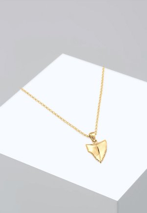 Gold necklace featuring a shark tooth-shaped pendant with serrated edges, attached to a delicate chain. Simple and sleek design.