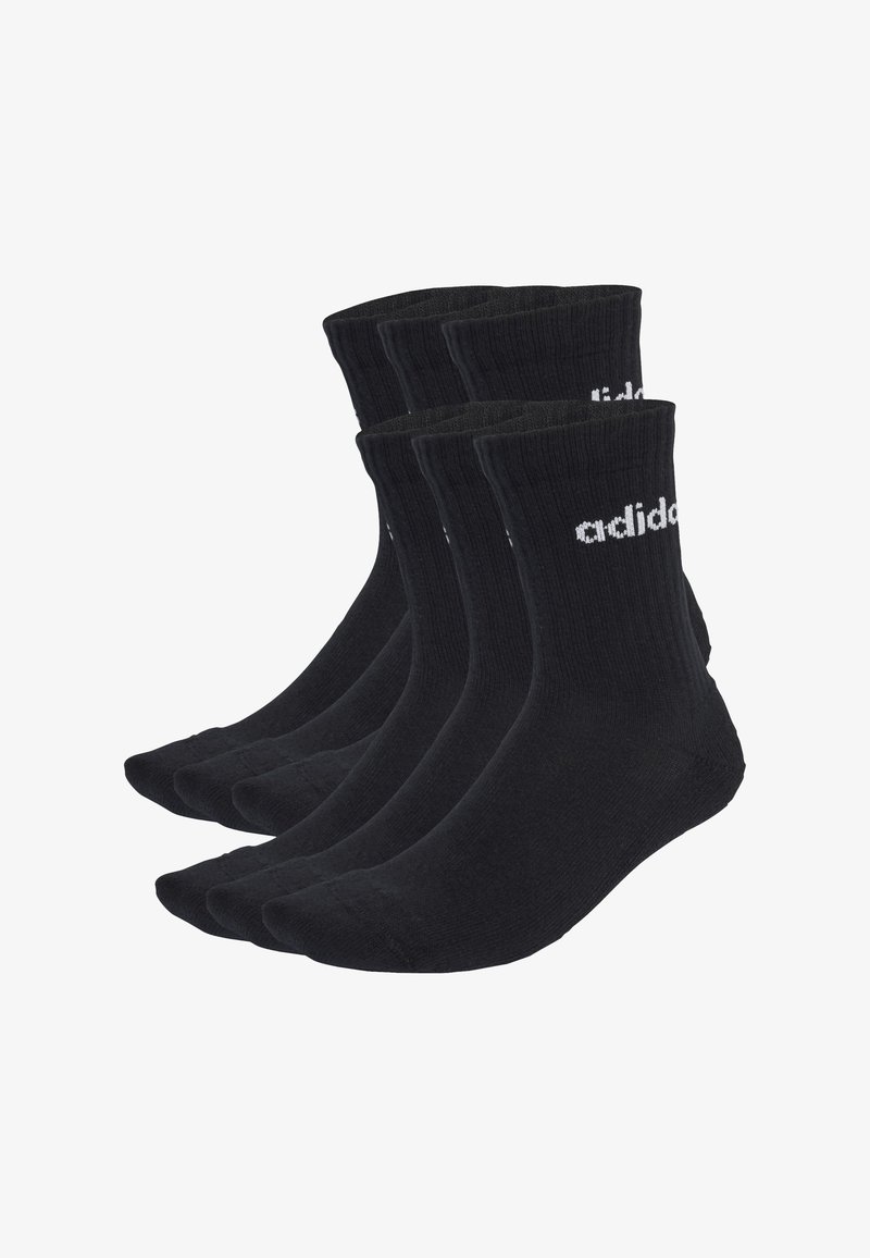 Calcetines de algodón negros en un paquete de cuatro, con textura acanalada, de longitud media y con un logotipo blanco impreso en el lado exterior.