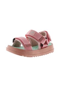 Sandalias rosas con correas ajustables, suelas de goma con agarre y una plantilla verde. El diseño incluye cierres de gancho y bucle para facilitar su uso.