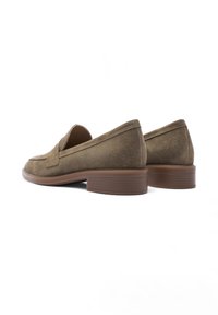 Suede loafers in olive green with a rounded toe, flat brown heel, and minimalistic design. Smooth texture with a subtle stitching detail.