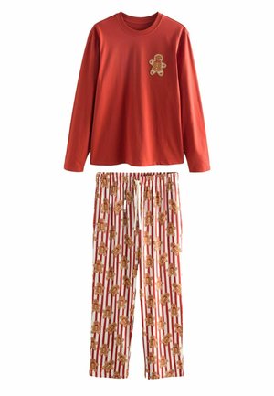 Red long-sleeve pajama top with a gingerbread man applique, paired with white pants featuring a gingerbread pattern on red stripes.