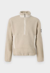 Beige fleece genser med høy krage, kvart glidelås foran og to lommer foran. Strukturert stoff med kontrasterende beige detaljer.