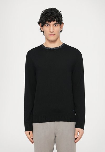 Black sweater with a crew neck and ribbed cuffs. Soft material with a smooth texture. Features a contrasting knit detail at the neckline.