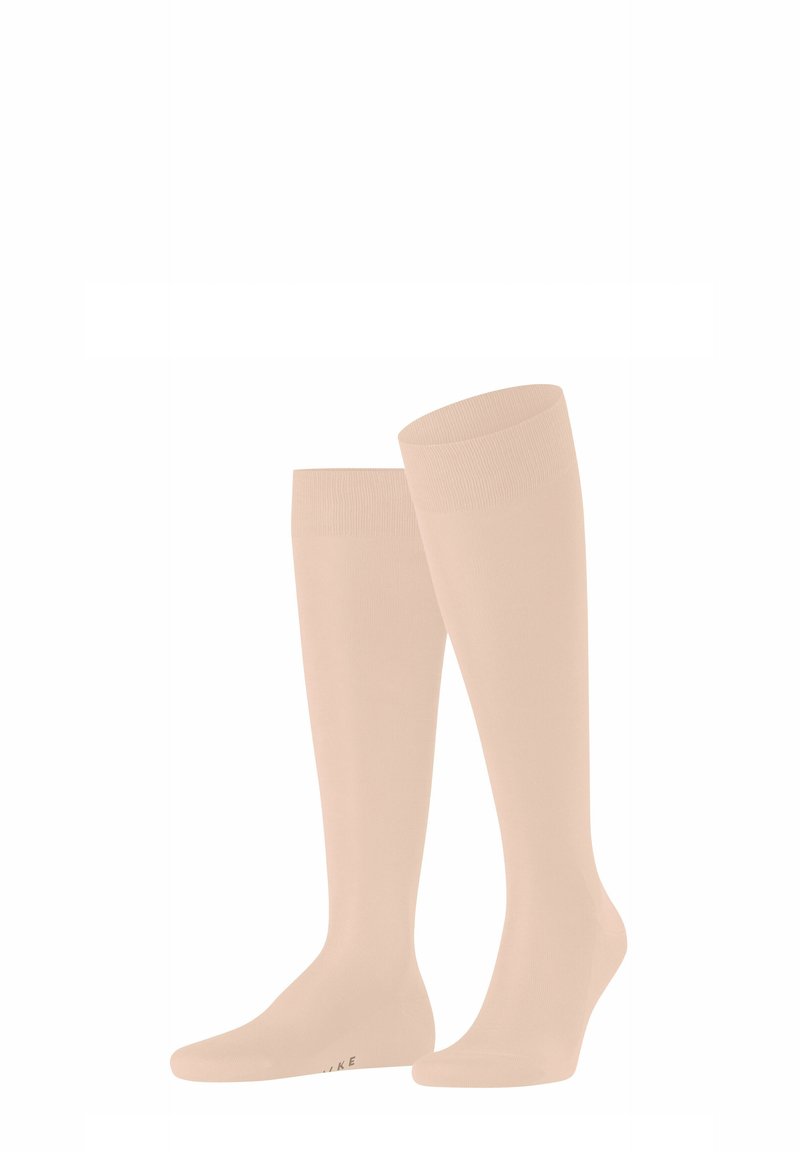 Calze di colore beige chiaro, fino al ginocchio, realizzate in un materiale elastico e liscio. Presentano un bordo superiore a coste e una punta senza cuciture.