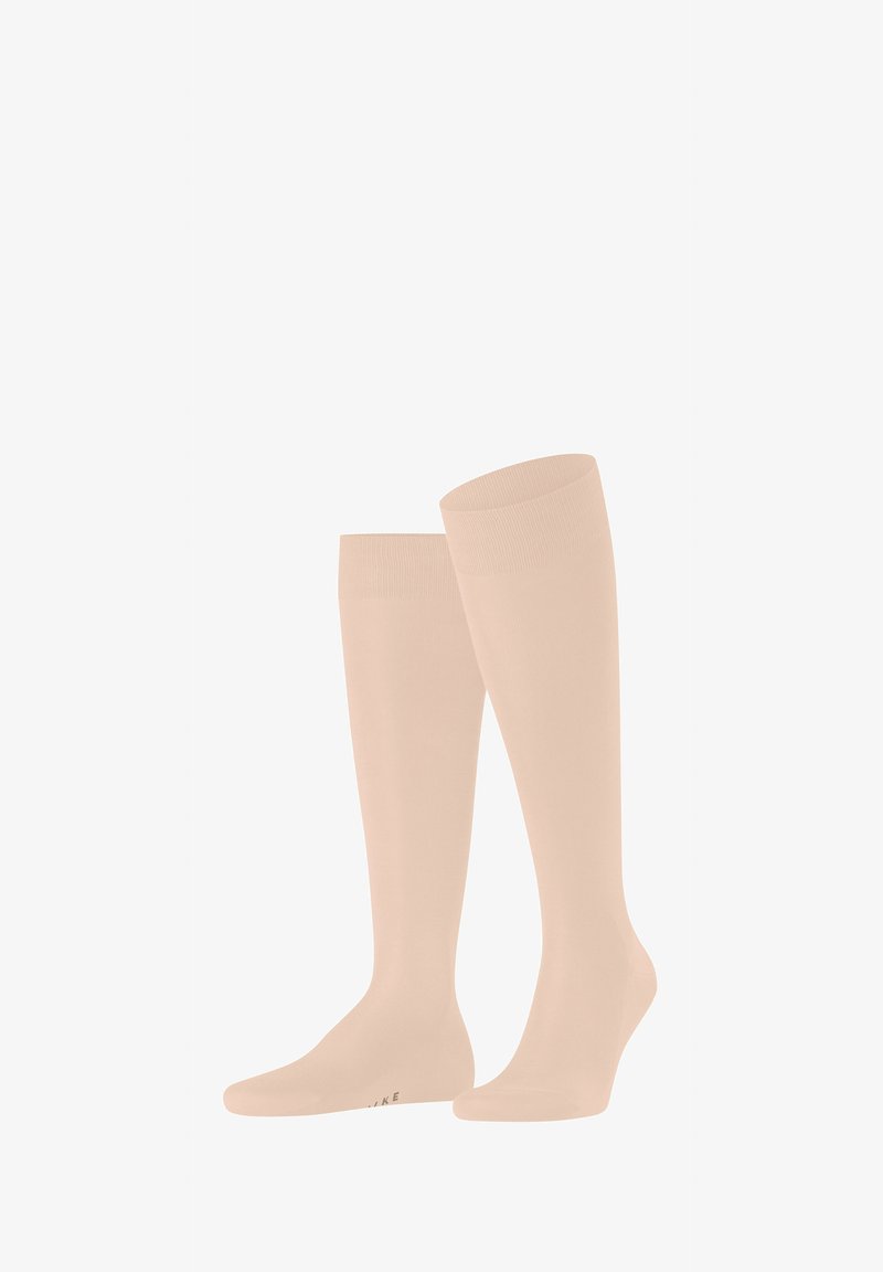 Knielange, hellbeige Socken aus einem glatten, elastischen Material. Mit einem gerippten oberen Bund und einer nahtlosen Fußspitze.
