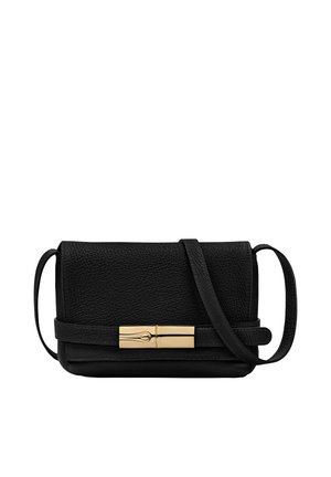 Black textured leather crossbody bag with gold rectangular clasp and adjustable strap against white background.