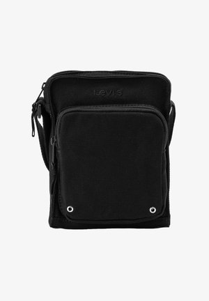 Sac bandoulière compact en toile noire Levi's avec poche avant zippée et sangle d'épaule réglable, deux œillets métalliques sur le coin de la poche.